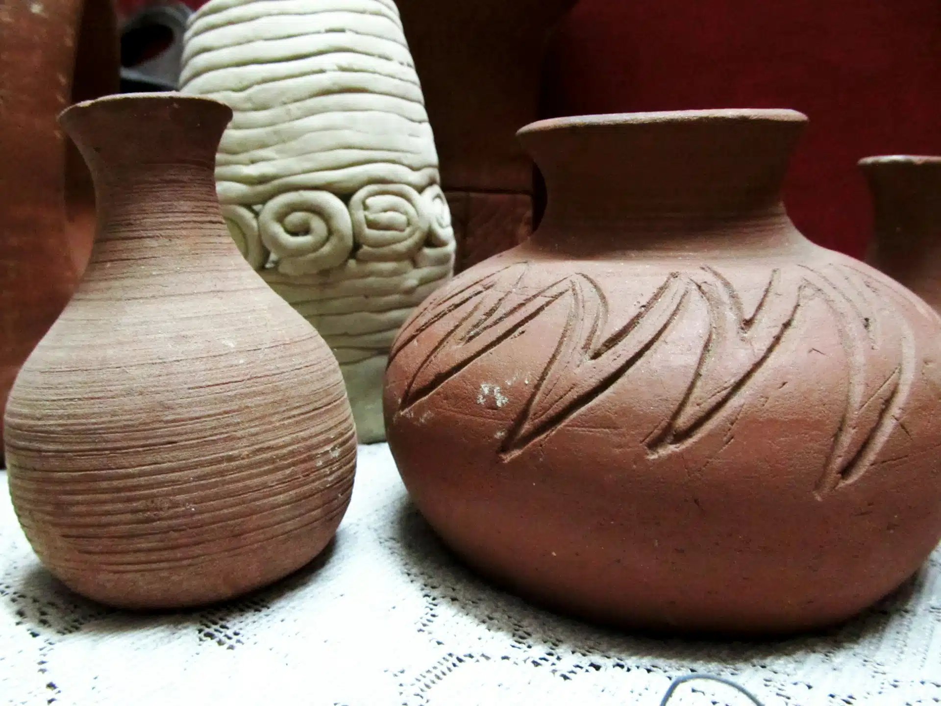 Α group of three vases sitting on top of a table Α group of three vases sitting on top of a table